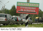 Автомобильный пункт пропуска и таможенного контроля "Красное" на границе России и Белоруссии. Указатель "Зеленая карта. Страхование на Беларусь" и колонна автомобилей. (2007 год). Редакционное фото, фотограф Юрий Пирогов / Фотобанк Лори