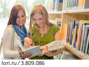 Счастливые студентки в библиотеке. Стоковое фото, фотограф CandyBox Images / Фотобанк Лори