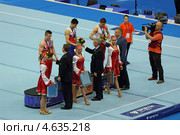 Чемпионат Европы по спортивной гимнастике 2013 года. Москва, СК "Олимпийский". Награждение победителей состязаний на перекладине - Эмин Гарибов, Сэм Олдэм (Sam Oldham) и Александр Царевич. Редакционное фото, фотограф Игорь Долгов / Фотобанк Лори