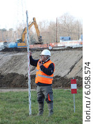 A foreman taking measure onsite. Стоковое фото, фотограф Phovoir Images / Фотобанк Лори