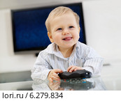 Baby boy playing with remote control. Стоковое фото, агентство BE&W Photo / Фотобанк Лори