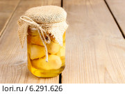 Glass jar of pickled mushrooms on wooden table. Autumn dish. Стоковое фото, агентство BE&W Photo / Фотобанк Лори