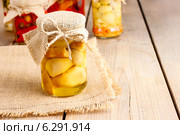 Glass jar of pickled mushrooms on wooden table. Autumn dish. Стоковое фото, агентство BE&W Photo / Фотобанк Лори