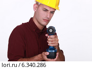 Tradesman aiming his power tool. Стоковое фото, фотограф Phovoir Images / Фотобанк Лори