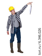Repulsed tradesman dangling a clipboard. Стоковое фото, фотограф Phovoir Images / Фотобанк Лори