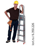 Haughty tradesman posing with a stepladder. Стоковое фото, фотограф Phovoir Images / Фотобанк Лори