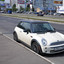 Автомобиль Mini Cooper, припаркованный у тротуара на Строгинском шоссе (2012 год). Редакционное фото, фотограф Дмитрий Абушкин / Фотобанк Лори