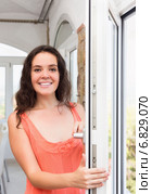 Brunette staying near plastic windows. Стоковое фото, фотограф Яков Филимонов / Фотобанк Лори
