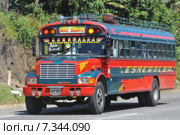 Chicken bus (Camioneta) colloquial name a colorful modified and decorated bus that transports goods and people between communities in Honduras and Guatemala.Guatemala, Antigua, typical colorful and decorated bus. Редакционное фото, агентство BE&W Photo / Фотобанк Лори