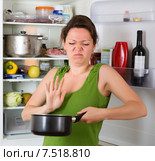 Woman holding nose near refrigerator. Стоковое фото, фотограф Яков Филимонов / Фотобанк Лори
