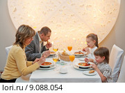 Happy family enjoying meal sitting at re. Стоковое фото, фотограф Roberts Ratuts / PantherMedia / Фотобанк Лори