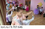 Сцена в детском садике с нарядными парами, танцующими вальс на выпускном балу (2015 год). Редакционное видео, видеограф Кекяляйнен Андрей / Фотобанк Лори