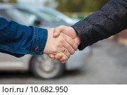Рукопожатие на фоне проданного автомобиля. Стоковое фото, фотограф Иван Карпов / Фотобанк Лори