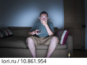 man covering mouth watching tv. Стоковое фото, фотограф Lee Avison / PantherMedia / Фотобанк Лори