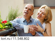 Mature couple on balcony with coffee. Стоковое фото, фотограф Яков Филимонов / Фотобанк Лори