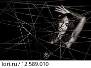 Young woman entangled the net of ropes. Стоковое фото, фотограф Art Konovalov / Фотобанк Лори