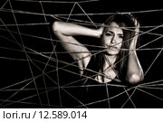 Young woman entangled the net of ropes. Стоковое фото, фотограф Art Konovalov / Фотобанк Лори