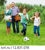 Happy family of four people playing football. Стоковое фото, фотограф Яков Филимонов / Фотобанк Лори