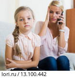 Worried mother calling doctor for daughter with abdominal pains. Стоковое фото, фотограф Яков Филимонов / Фотобанк Лори
