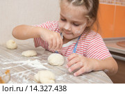 Девочка с энтузиазмом посыпает мукой слепленный пирожок. Стоковое фото, фотограф Иванов Алексей / Фотобанк Лори