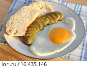 Яичница-глазунья с огурцом и хлебом на тарелке. Стоковое фото, фотограф lana1501 / Фотобанк Лори