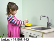 Двухлетняя девочка играет в детской кухне. Детский сад. Стоковое фото, фотограф Ирина Борсученко / Фотобанк Лори
