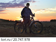 Велосипедист, подсвеченный заходящим солнцем. Стоковое фото, фотограф Анатолий Матвейчук / Фотобанк Лори