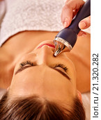Young woman receiving electric facial massage. Стоковое фото, фотограф Gennadiy Poznyakov / Фотобанк Лори
