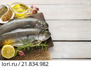 Two rainbow trouts on rustic wooden table, copy space. Стоковое фото, агентство BE&W Photo / Фотобанк Лори