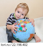 Little white boy in jeans laid his head on the globe. Baby embraced the globe. We need to protect the planet for Children. Маленький белый мальчик в джинсах положил голову на земном шаре. Ребенок обнял весь земной шар. Мы должны защитить планету для детей. Стоковое фото, фотограф Александров Никита / Фотобанк Лори