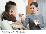 Concerned mother giving mixture to son with quinsy. Стоковое фото, фотограф Яков Филимонов / Фотобанк Лори