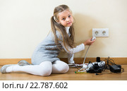 Little girl playing with sockets at home. Стоковое фото, фотограф Яков Филимонов / Фотобанк Лори