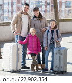 Family portrait of travellers with wheeled trollers in spring day. Стоковое фото, фотограф Яков Филимонов / Фотобанк Лори