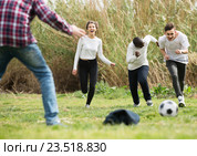 girl and three boys playing football in spring park and smiling. Стоковое фото, фотограф Яков Филимонов / Фотобанк Лори