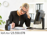 businesswoman looking at business papers in office. Стоковое фото, фотограф Оксана Кузьмина / Фотобанк Лори