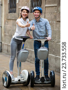 Positive couple going sightseeing by segways. Стоковое фото, фотограф Яков Филимонов / Фотобанк Лори