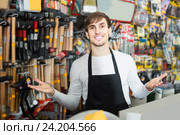 male seller posing at tooling section of household store. Стоковое фото, фотограф Яков Филимонов / Фотобанк Лори