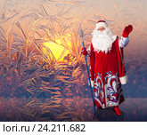 Santa Claus on the window frosty patterns background. Стоковое фото, фотограф Владимир Мельников / Фотобанк Лори