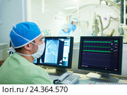Interventional cardiology. Male surgeon doctor at operation. Стоковое фото, фотограф Дмитрий Калиновский / Фотобанк Лори