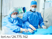 Interventional cardiology. Male surgeon doctor at operation. Стоковое фото, фотограф Дмитрий Калиновский / Фотобанк Лори