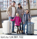 Family portrait of travellers with wheeled trollers in spring day. Стоковое фото, фотограф Яков Филимонов / Фотобанк Лори