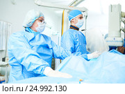 Interventional cardiology. Male surgeon doctor at operation. Стоковое фото, фотограф Дмитрий Калиновский / Фотобанк Лори