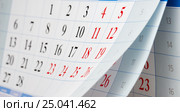 Flipping of three calendar sheets with black and red numbers. Стоковое фото, фотограф Сергей Федулов / Фотобанк Лори