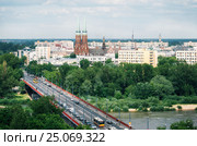 Aerial view of cityscape of Warsaw, Slasko-Dabrowski bridge over the the Vistula river on the foreground and Cathedral of St. Michael the Archangel and St. Florian the Martyr among the buildings of Praga district on the background. Poland. Стоковое фото, фотограф Andrei Bortnikau / Фотобанк Лори
