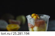 Slices of Cape Gooseberry Adds a Fruit Cocktail Cup. Стоковое видео, видеограф Станислав Панкратов / Фотобанк Лори