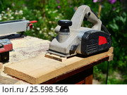 Electric planer is on board on the nature. Стоковое фото, фотограф Володина Ольга / Фотобанк Лори