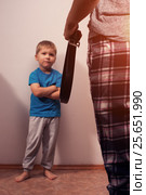 Mother holding belt to punish little son. Стоковое фото, фотограф Pavel Biryukov / Фотобанк Лори
