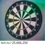 Vintage dart board on dark wall. Стоковое фото, фотограф Lora Liu / Фотобанк Лори
