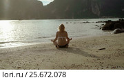 Young woman on a beach practise yoga in bikini. Стоковое видео, видеограф Алексей / Фотобанк Лори