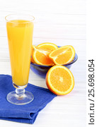 Glass of orange juice  on a light wooden background. Стоковое фото, фотограф Феликс Хромых / Фотобанк Лори